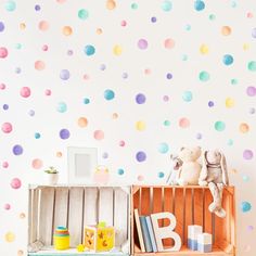 a child's room with polka dot wall decals on the walls and bookshelf