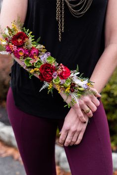 a woman wearing purple leggings with flowers on her arm