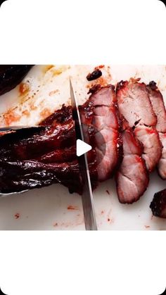 there is a knife cutting up meat on the plate with it's end cut off