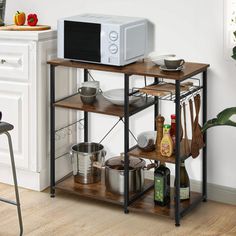 a microwave oven sitting on top of a wooden shelf