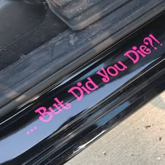 a pink sticker on the side of a car that says, build did you die?