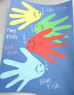 two fish and one fish are painted on a piece of paper