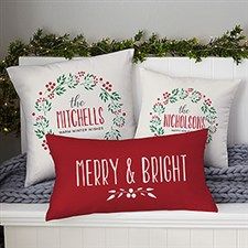 two christmas pillows sitting on top of a bed next to a pillow that says merry and bright