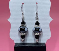 I created these earrings with black and white lampwork beads, black Swarovski crystals, sterling silver bead caps, sterling silver spacer beads and small round sterling silver beads. The earrings measure approximately 1 3/4 inches from the top of the sterling silver earwire. Please note that photos are enlarged to show detail. Click here to see other earrings in my shop: https://www.etsy.com/shop/JewelryDesignsByRita?section_id=14765680 I have been designing and making jewelry since 2010. I use Black Czech Glass Jewelry With Ear Wire, Silver Earrings With Black Round Beads, Gift Black Sterling Silver Beaded Earrings, Black Beaded Sterling Silver Earrings, Black Earrings With Silver Beads As Gift, Shoujo Life, Crystals Swarovski, Lampwork Earring, Onyx Bead