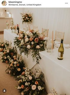 the table is set with flowers and candles for an elegant wedding reception at whimbers forest, united kingdom