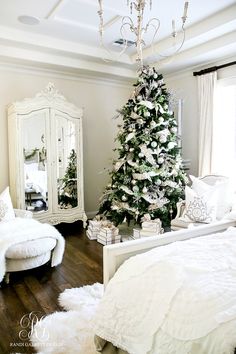 a decorated christmas tree in a white bedroom