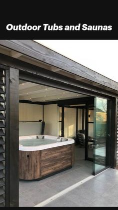 an outdoor jacuzzi tub in the middle of a patio with sliding glass doors