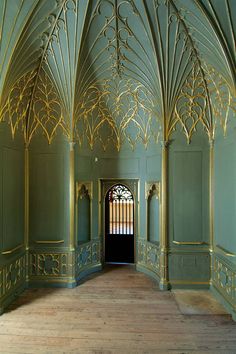 an ornately decorated room with wooden floors and green walls