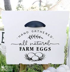 a sign that says, hand gathered all natural farm eggs in front of some flowers