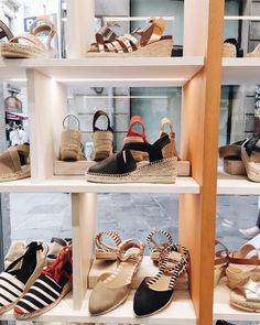 several different types of shoes on display in a store