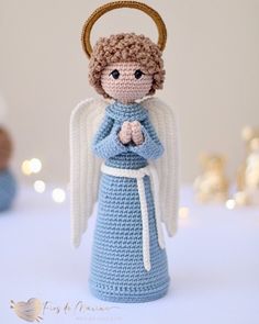 a crocheted angel figurine with a halo around its neck