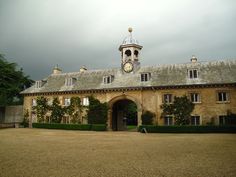 a large building with a clock on it's face in front of a cloudy sky