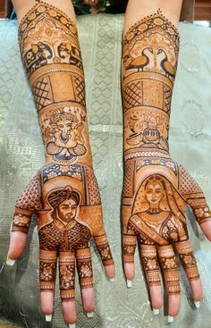 two hands that are decorated with henna and tattoos on them, one is holding the other