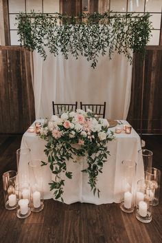 a table with candles and flowers on it