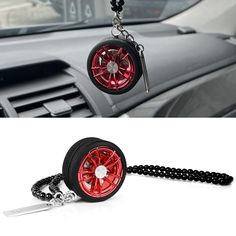 a car keychain with a wheel and chain hanging from it's center console