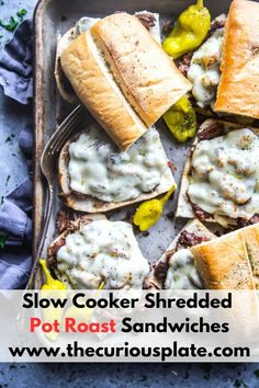 slow cooker shredded pot roast sandwiches in a baking pan with the title above it