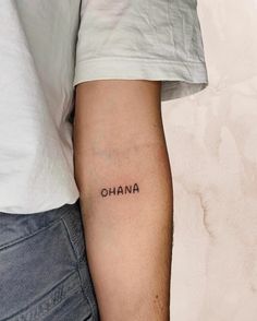 a man's arm with the word ohana tattooed on it, and his name in cursive font