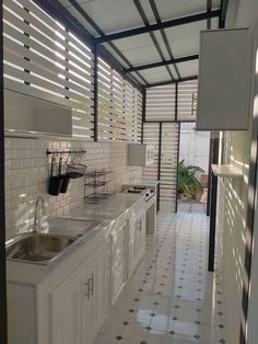 a kitchen with white cabinets and tile flooring