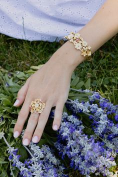 Epitomizing the beauty of a bouquet of flowers, the Wildflowers Gathered Ring is meticulously handcrafted from 18k gold-dipped brass, adorned with carefully selected colors of hand-painted enamel. A luxurious embodiment of sophistication, it effortlessly marries timeless elegance with a delightful sense of whimsy. 18K Gold Plated Brass Hand Painted Enamel 1" D Yellow Gold Enamel Flower Jewelry, Yellow Gold Enamel Flower Ring Gift, Luxury Flower-shaped Jewelry With Rose Cut Diamonds, Gold Enamel Flower Ring For Anniversary, Gold Flower-shaped Enamel Ring, Yellow Gold Enamel Jewelry With Rose Cut Diamonds, Rose Gold Enamel Wedding Rings, Elegant Rose Gold Enamel Rings, Luxury Flower-shaped Jewelry For Wedding