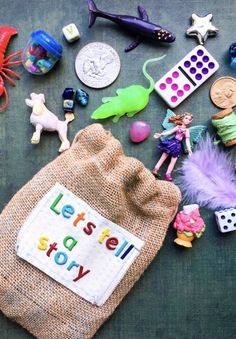 there are many toys on the table and one has a sign that says let's tell story