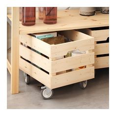 a wooden table with two containers on wheels