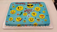 a birthday cake with many smiley faces on it