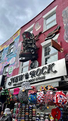 there are many items on display in front of the building that is painted red and white