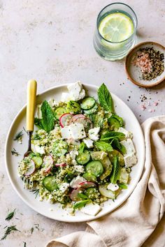 a white plate topped with cucumbers, radishes and feta cheese