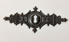 an ornate metal door handle with a keyhole