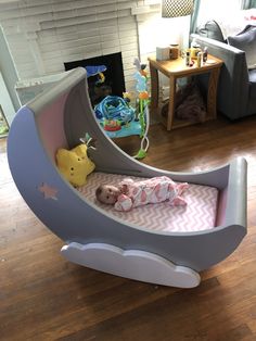 a baby is laying in a bed shaped like a boat