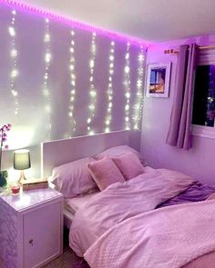 a bedroom with purple lights hanging from the ceiling