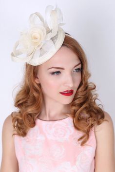 This vintage-inspired fascinator is as timeless as a fairytale. Let your personality add life to its floral center and ribbon loop accents. It's round base and slip-on headband will allow you to look flawless and enjoy any event with ease! - Easy wear headband - Round sinamay base Elegant Cream Headband For Spring, White Vintage Fascinator For Royal Ascot, Spring Cream Mini Hat Headband, Elegant Hair Accessories For Garden Party And Kentucky Derby, Elegant Cream Fascinator For Vintage Events, Adjustable Cream Headpiece For Garden Party, Adjustable Cream Headpieces For Garden Party, Elegant Beige Hair Accessories For Spring, Elegant Beige Headpieces With Handmade Flowers