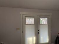 a bedroom with two doors and white walls