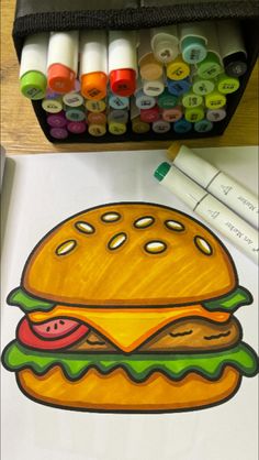 a drawing of a hamburger with crayons next to it