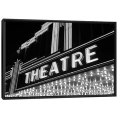 the theatre sign lit up in black and white