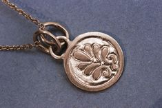 "A solid 14k or 18 rose gold coin pendant necklace for women. This solid gold necklace has a vintage style coin as a pendant. The pendant has a gold loop on top, in which 2 gold loops from the necklace enter and keep it in place. One side of the coin is decorated with a delicate embossed flower, the back of the coin is blank. This necklace is delicate but has a lot of character, and will upgrade any outfit you'll wear. This is a lovely necklace for everyday use, as for special occasions. Get thi Elegant Handmade Coin Necklace, Handmade Elegant Coin Necklace, Elegant Hammered Medallion Necklace Gift, Elegant Hammered Medallion Necklace As Gift, Gold Coin Pendant, Gold Coin Necklace, 18k Gold Necklace, Coin Pendant Necklace, Solid Gold Necklace