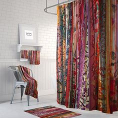 a colorful shower curtain in a bathroom with white brick walls and flooring on the side