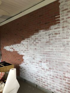 a brick wall with white paint on it