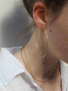 • Effortlessly stylish hoops which are elegant and whisper thin.• These large 12K Gold Filled Hoop earrings have a glistening hammered finish on all sides.• Super light and easy to wear.• Available in 3 sizes, perfect for every occasion. • Stylish packaging - options for a glassine bag or gift box -  see last photo.• Gift wrapping available at checkout.OPTIONS• 40 mm / 1.6 inches diameter  -  see photos 2, 4 - 6 • 50 mm / 2 inches diameter  - see photos 2, 3 shown in silver & 7 • 65 mm / 2.5 Gold Hoop Earrings Outfit, Big Gold Hoop Earrings, Large Gold Hoop Earrings, Hoop Earring Outfit, Large Silver Hoop Earrings, Big Hoop Earrings, Gold Filled Hoops, Loop Earrings, Hammered Sterling Silver