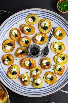 small appetizers on a blue and white plate with a spoon next to them