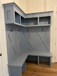 a gray bench sitting in the corner of a room