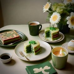 a table topped with plates and cups filled with cake