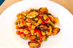 a white plate topped with stir fried vegetables