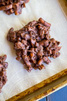 chocolate cookies are on top of parchment paper