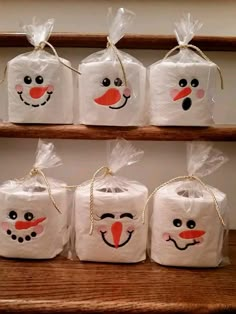 some bags with faces drawn on them sitting on a shelf