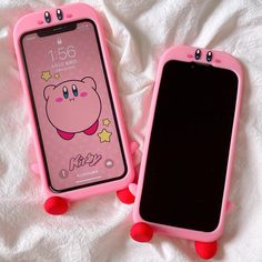 two pink cell phones sitting next to each other on top of a white sheet covered bed