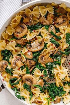 pasta with mushrooms and spinach in a pan