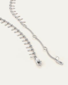 A series of micro stamped elements dangle from a detailed curb chain, catching the light beautifully. The water-durable Lumi Anklet includes three non-removable extender rings, making it easy to adjust to your ideal length. Finished in high-polish silver. rhodium ion plated steelstamped pendantslobster claspfinish: high polish product measurements:wearable at 21.29cm / 8.38", 23.34cm / 9.19", 25.56cm / 10.06", or 27.64cm / 10.88"chain width: 1.4mm / 0.06"pendant height: 6.1mm / 0.24"pendant width: 1.35mm / 0.05"weight: 2.45g / 0.086oz style: JB762-RHimported Silver Drop Chain Jewelry, Adjustable Silver Chain Bracelet With Extender, Silver Chain Bracelet With Extender, Dainty Silver Chain Bracelet With Lobster Clasp, Dainty Silver Link Charm Bracelet, Adjustable Dangle Jewelry In Metal, Metal Dangle Jewelry With Adjustable Length, Silver Dangle Metal Anklets, Sterling Silver Adjustable Link Bracelet