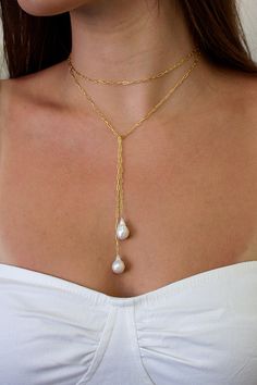 The Breathless Tie Lariat Necklace features a 36" signature brisbane chain with genuine baroque freshwater pearl ends. Designed to be worn different ways, wrap it twice and cross the ends or wear it long and cross the middle.  Lightweight and comfortable to wear.  Materials: 14K gold filled or sterling silver Closure: Beach Wedding Jewelry, Elizabeth Jewelry, Pearl Lariat Necklace, Minimal Jewelry, Lariat Necklace, Dainty Jewelry, Cute Jewelry, Pearl Jewelry, Jewelry Inspiration