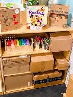 cardboard boxes are stacked on top of each other with pens and pencils in them